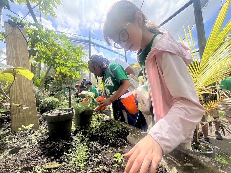 Student exploring soil on a school field trip at the farm